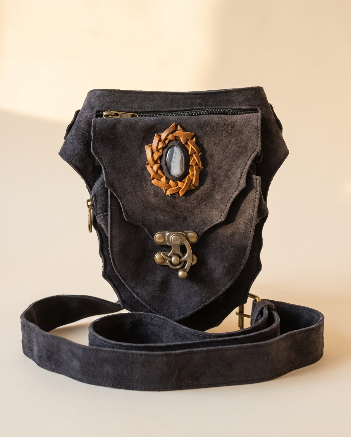 Black suede hip bag with stone and clasp, front view, by Ya Qalbi