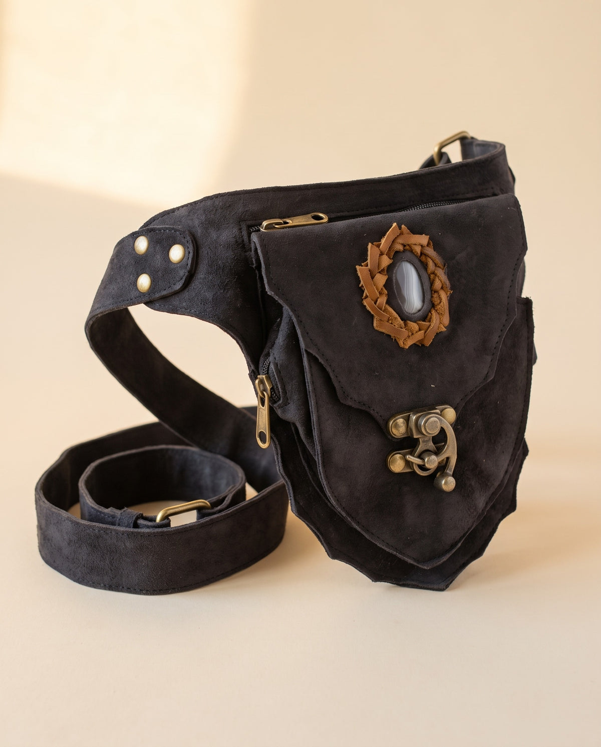 Black suede hip bag with stone and clasp, angled view, by Ya Qalbi