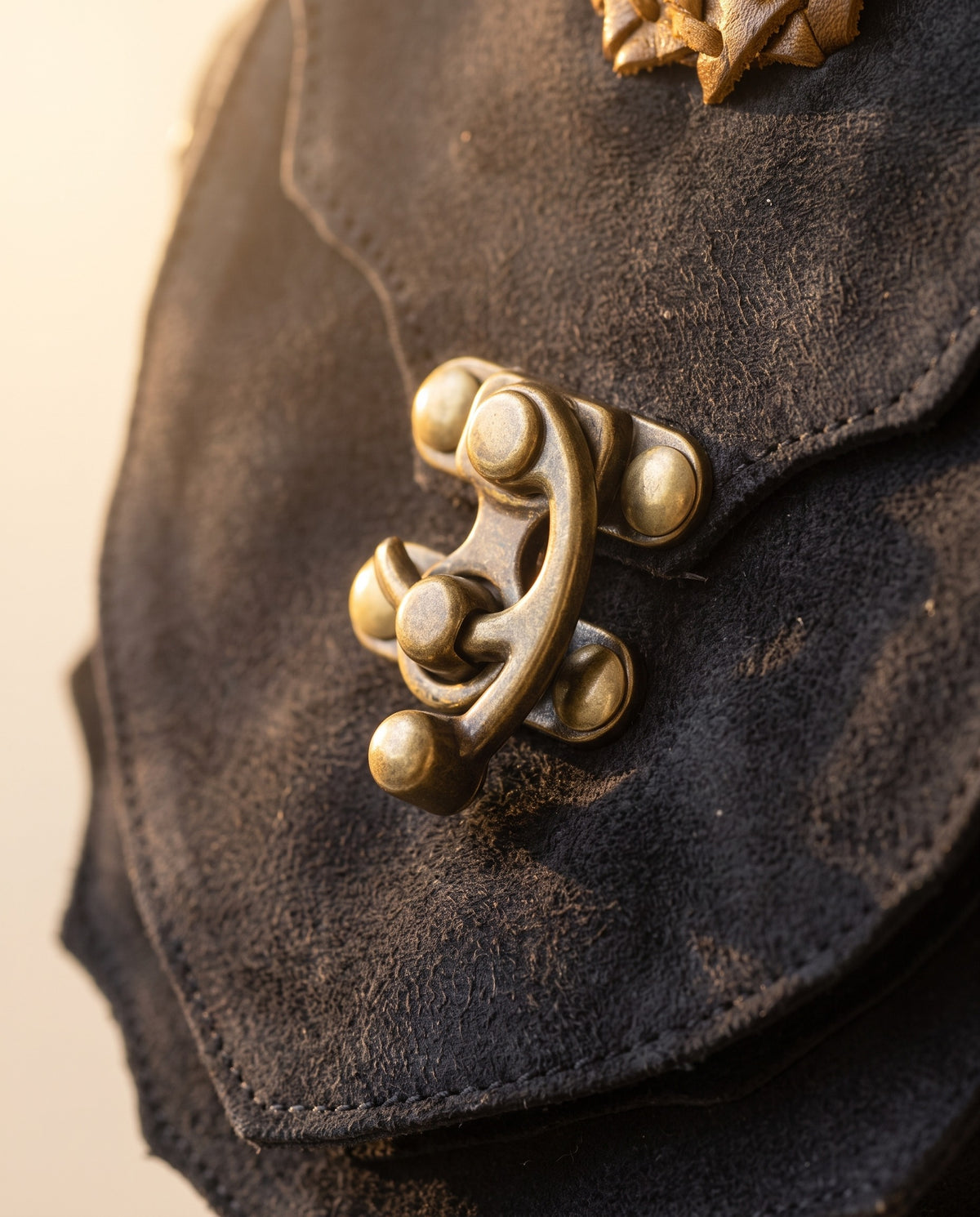 Black suede hip bag with stone and clasp, detail close-up, by Ya Qalbi