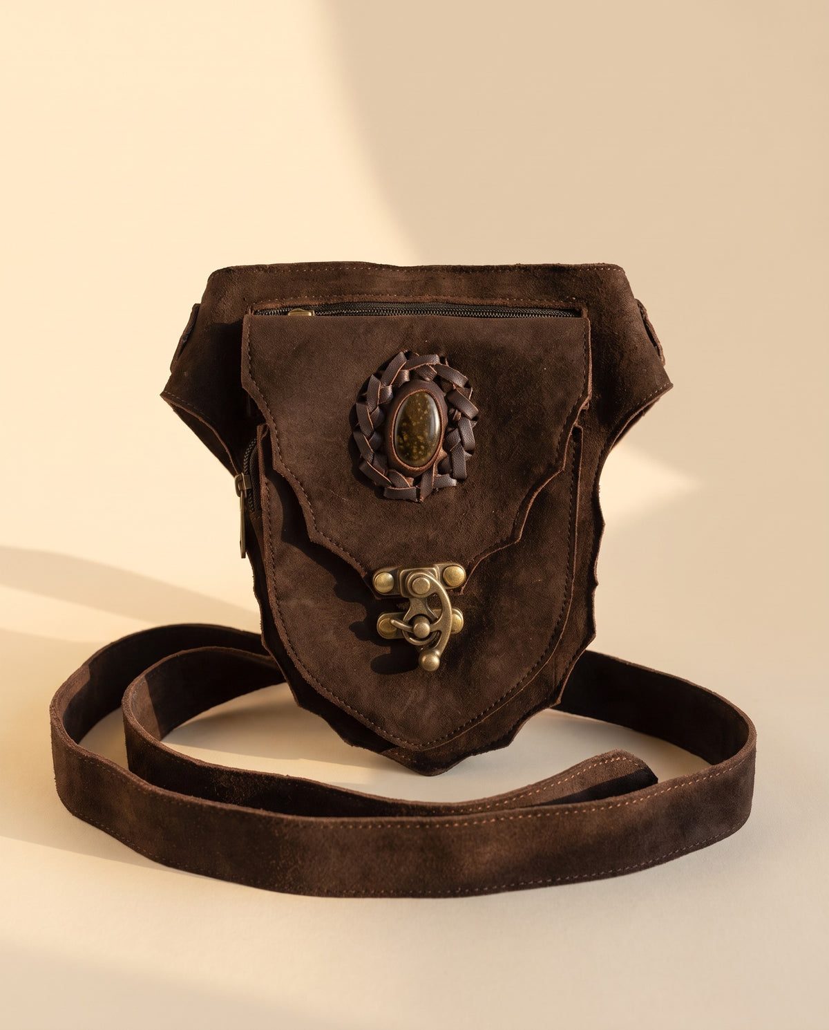 Dark brown suede hip bag with stone and clasp, front view, by Ya Qalbi