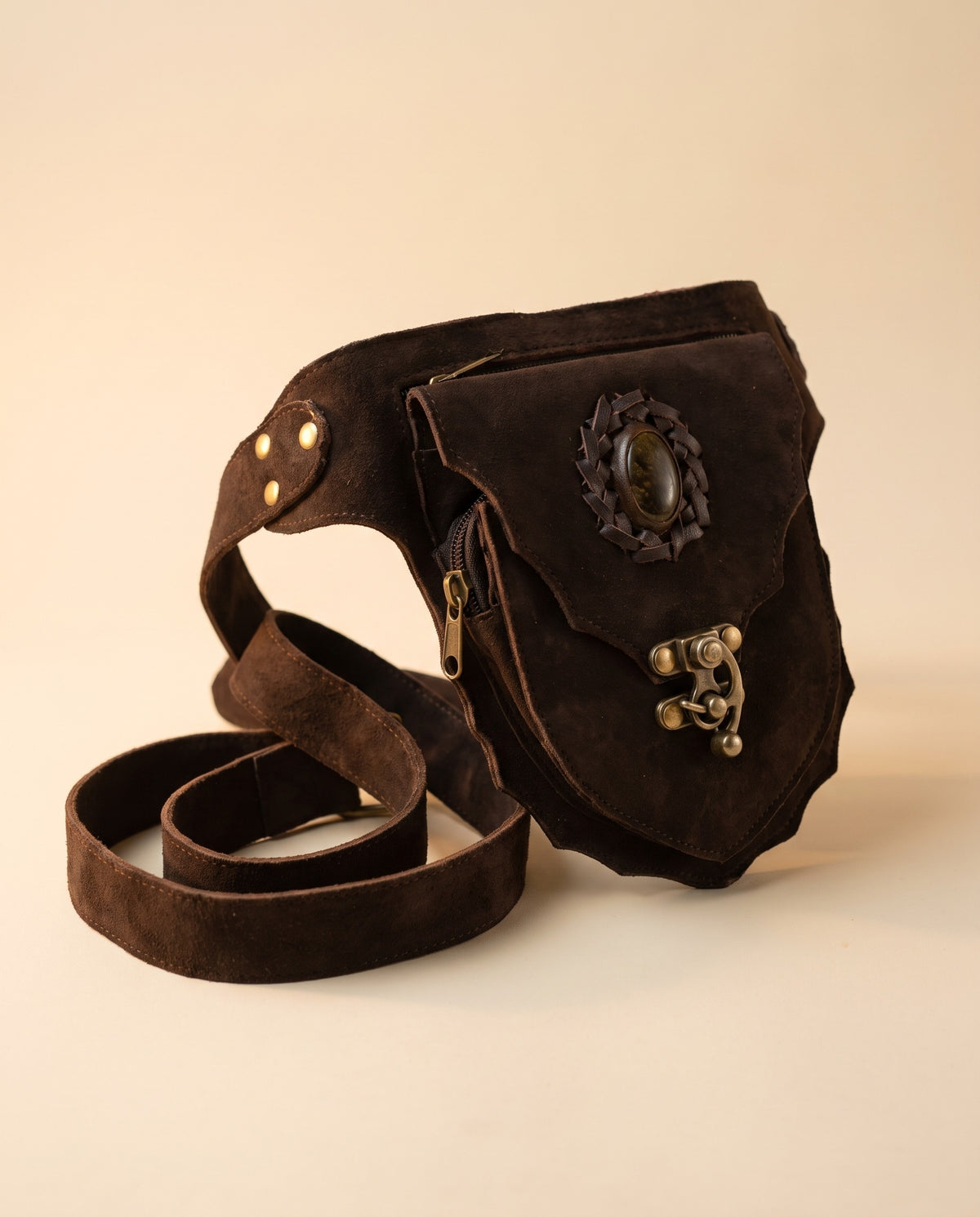 Dark brown suede hip bag with stone and clasp, angled view, by Ya Qalbi