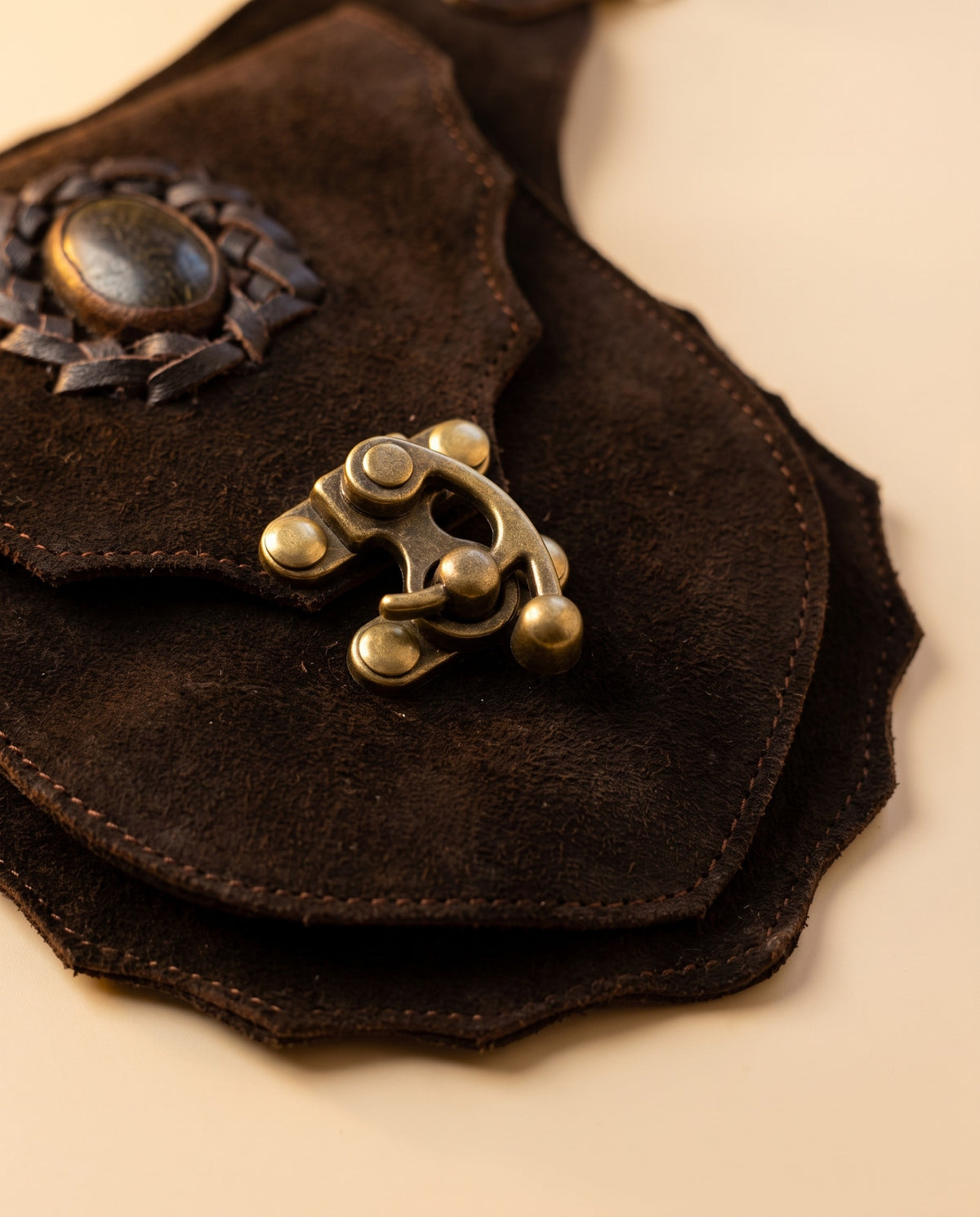 Dark brown suede hip bag with stone and clasp, detail close-up, by Ya Qalbi