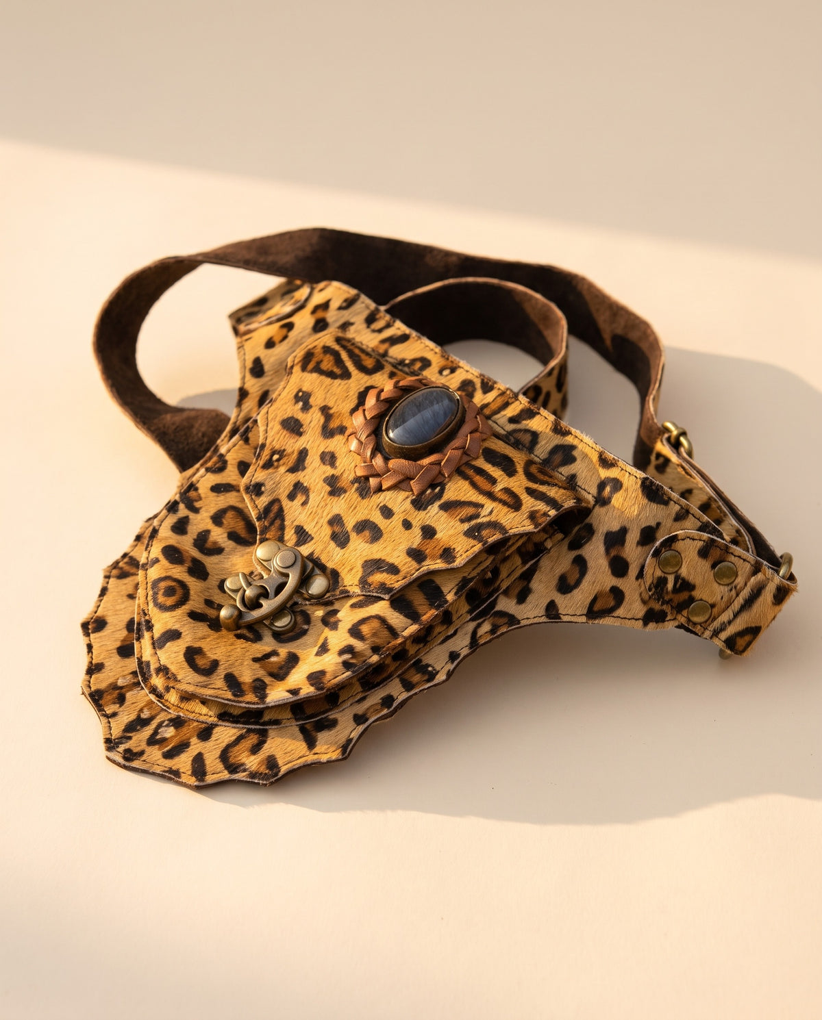 Leopard suede hip bag with stone and clasp, angled view, by Ya Qalbi