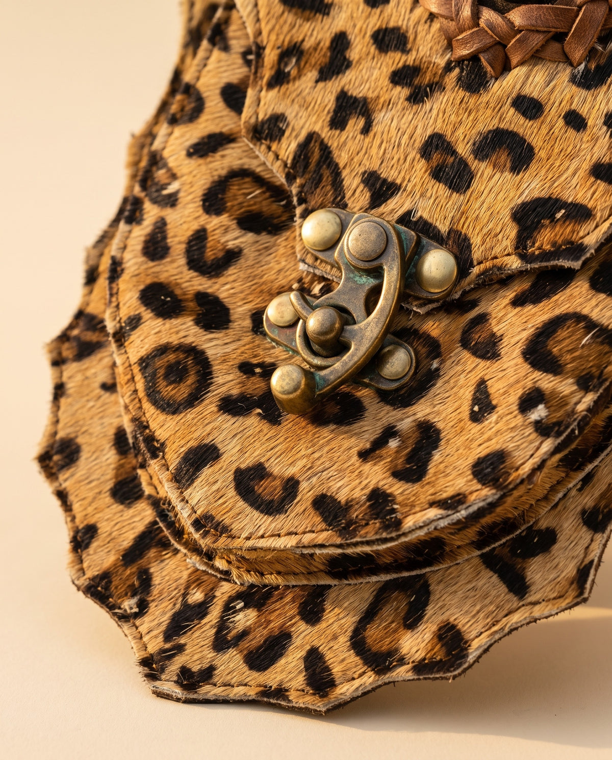 Leopard suede hip bag with stone and clasp, detail close-up, by Ya Qalbi