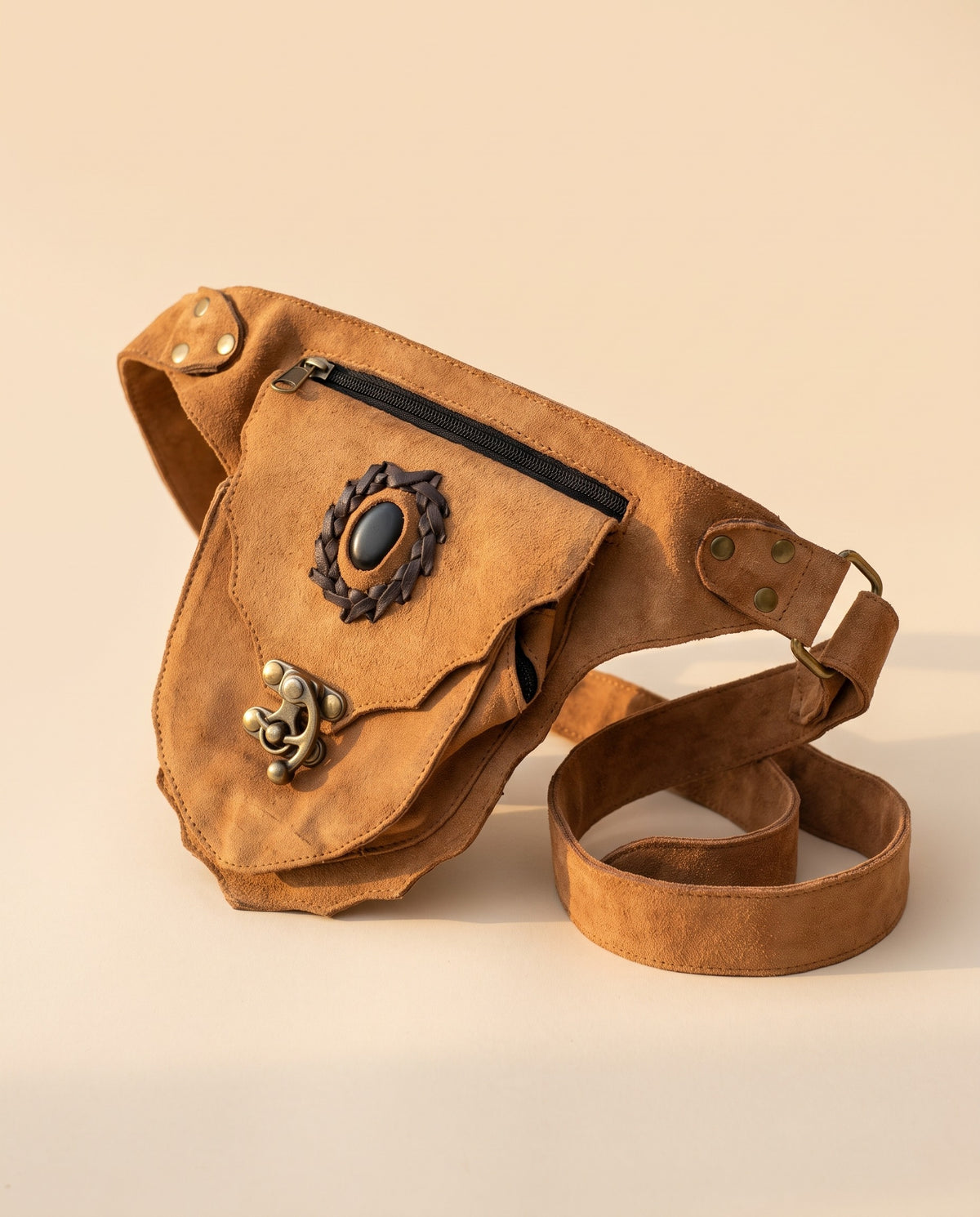 Tan suede hip bag with stone and clasp, angled view, by Ya Qalbi