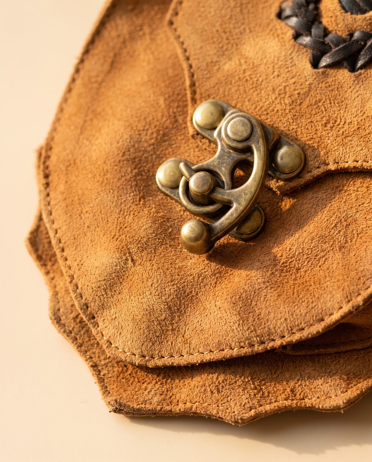 Tan suede hip bag with stone and clasp, detail close-up, by Ya Qalbi
