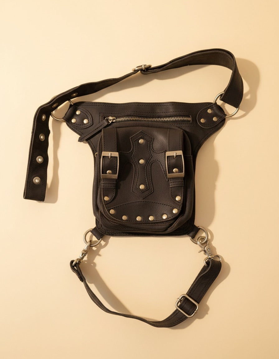 Black studded leather leg bag with buckles, front view, by Ya Qalbi