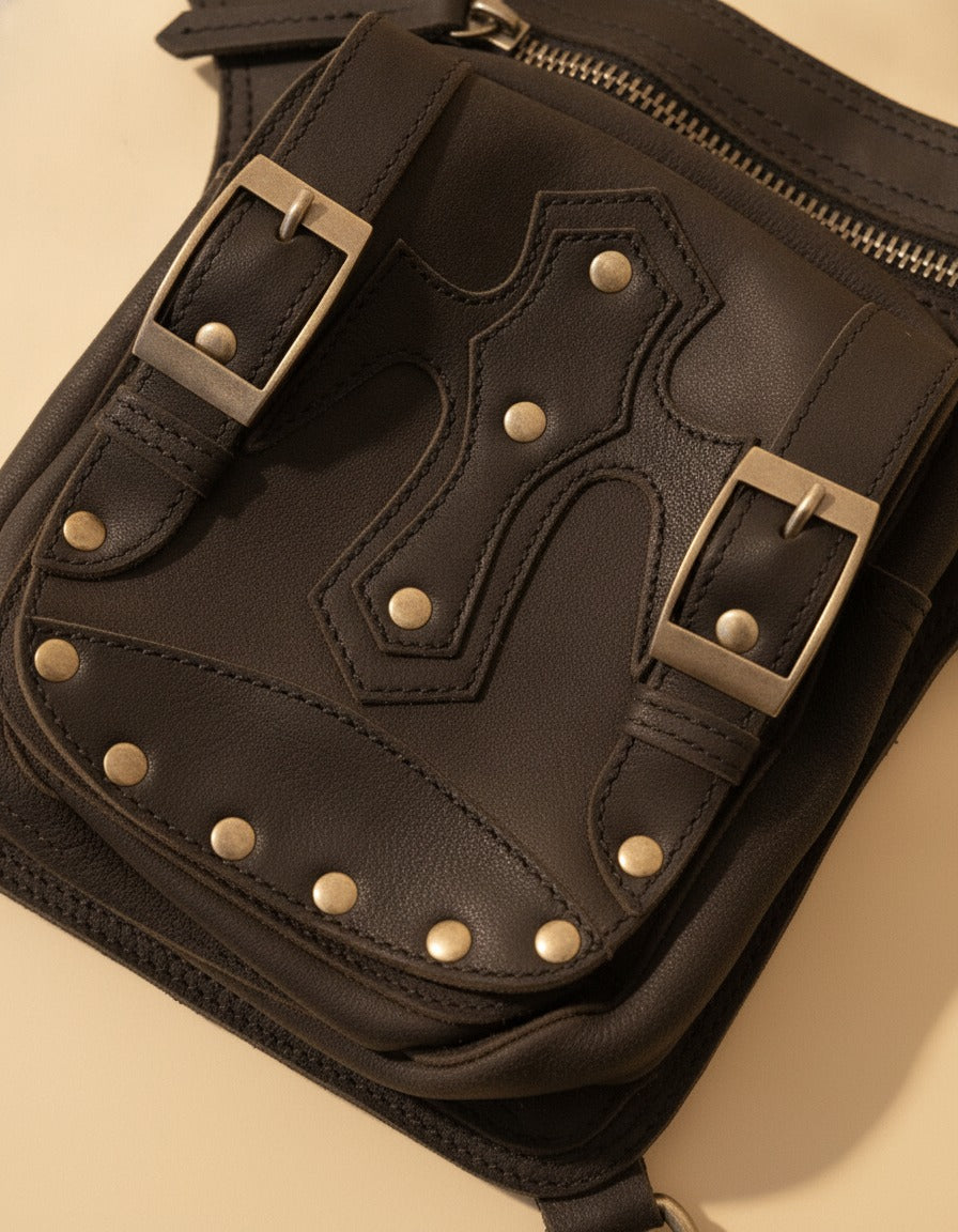 Black studded leather leg bag with buckles, detail close-up, by Ya Qalbi