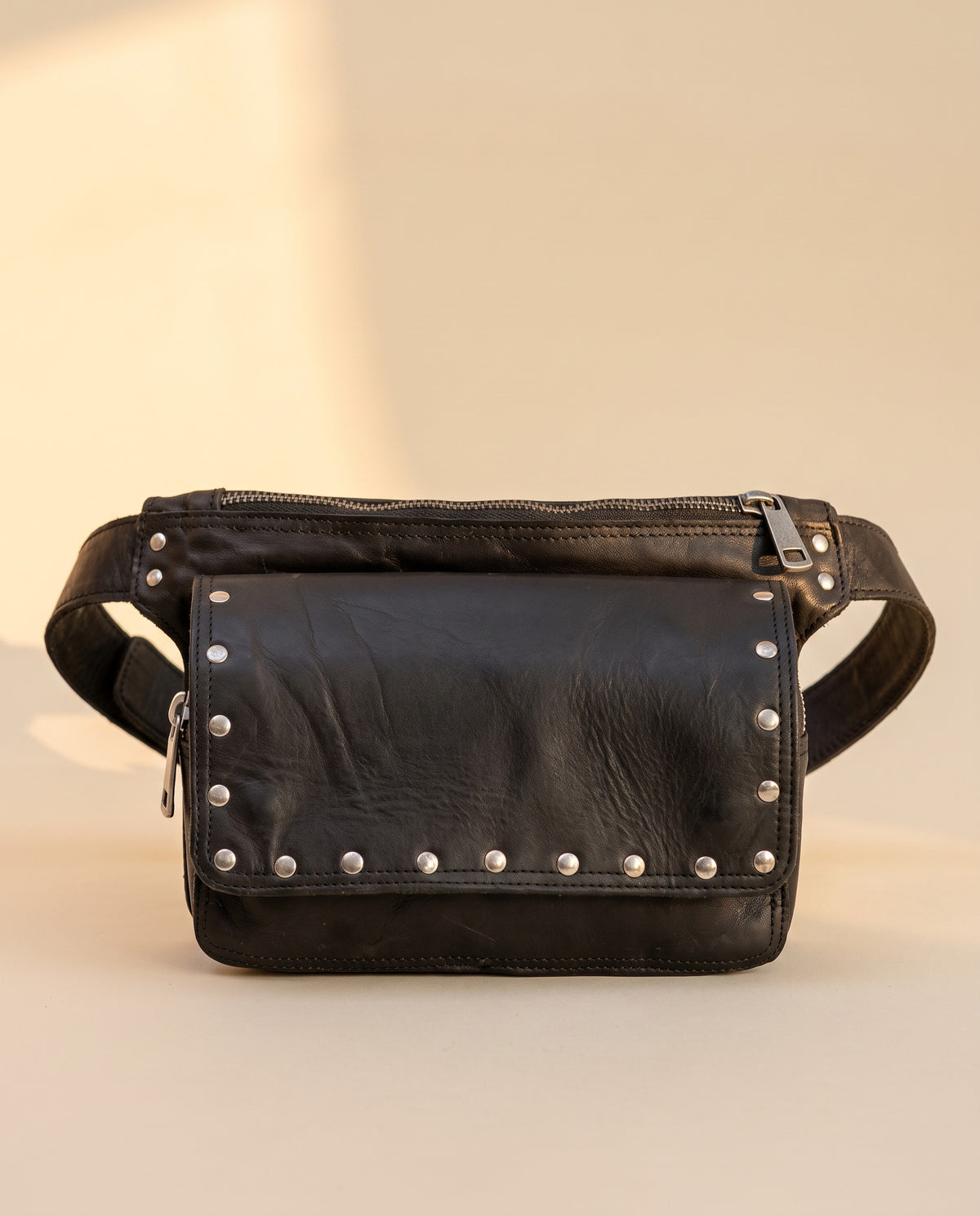 Black studded leather fanny pack, front view, by Ya Qalbi