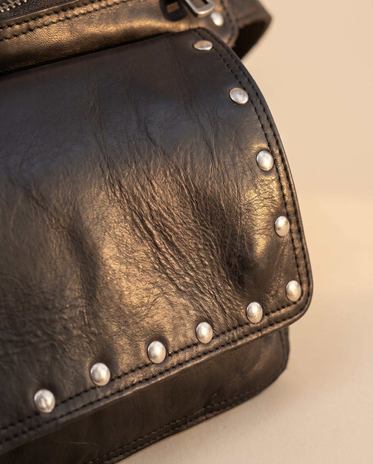 Black studded leather fanny pack, detail close-up, by Ya Qalbi