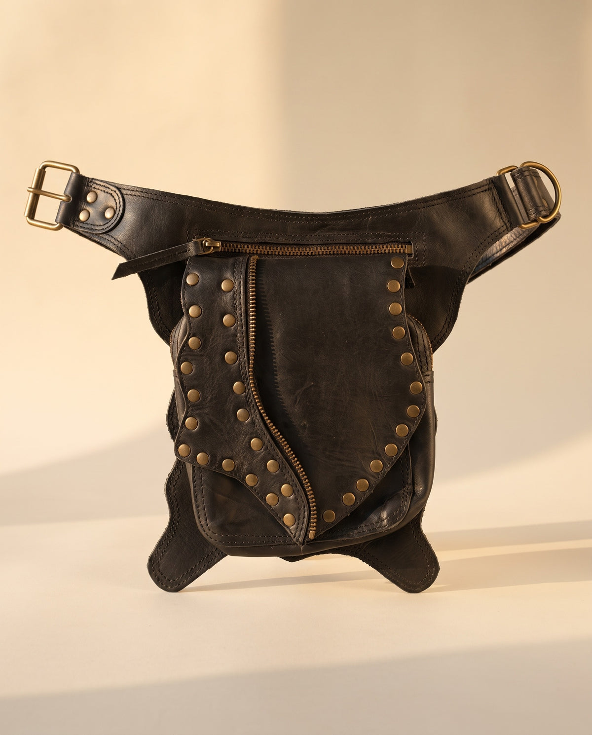 Black studded leather hip belt bag, front view, by Ya Qalbi