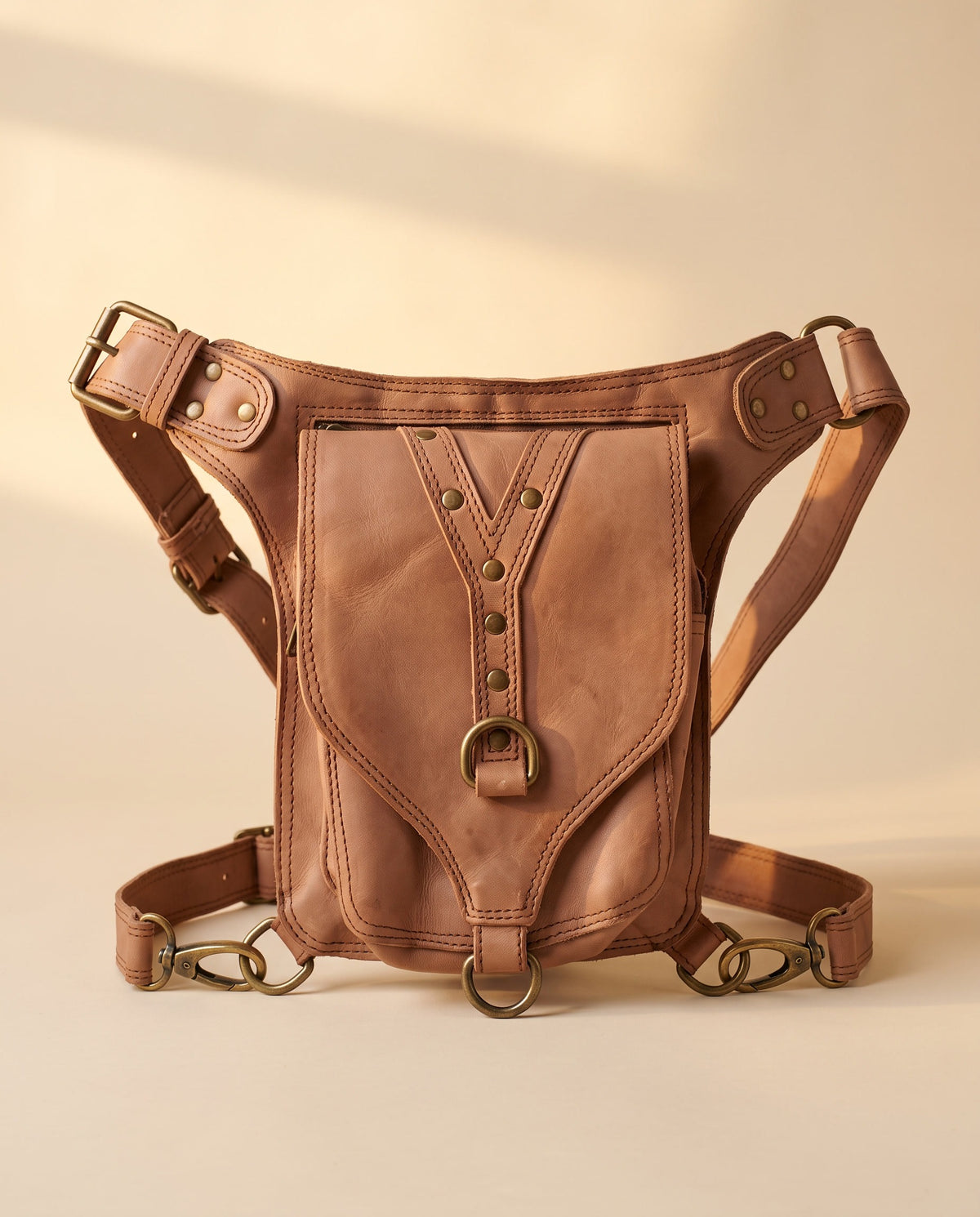 Blush studded leather hip belt bag, front view, by Ya Qalbi