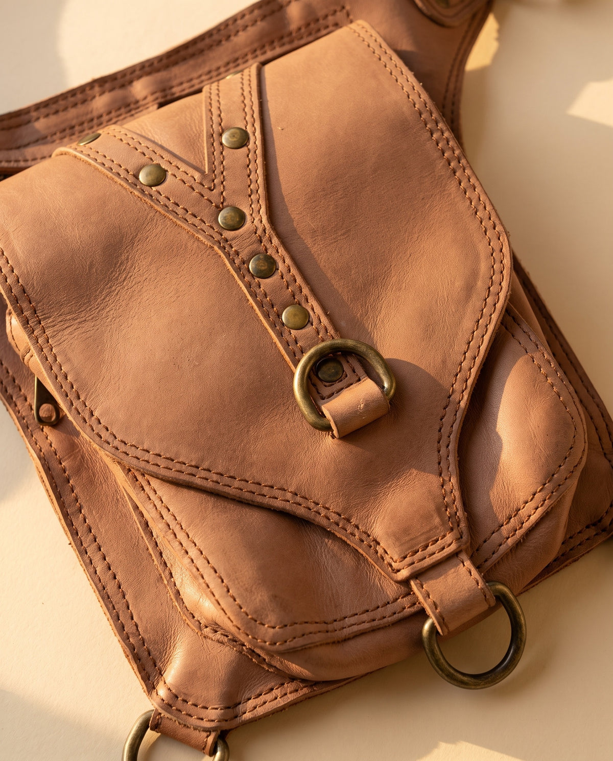 Blush studded leather hip belt bag, detail close-up, by Ya Qalbi