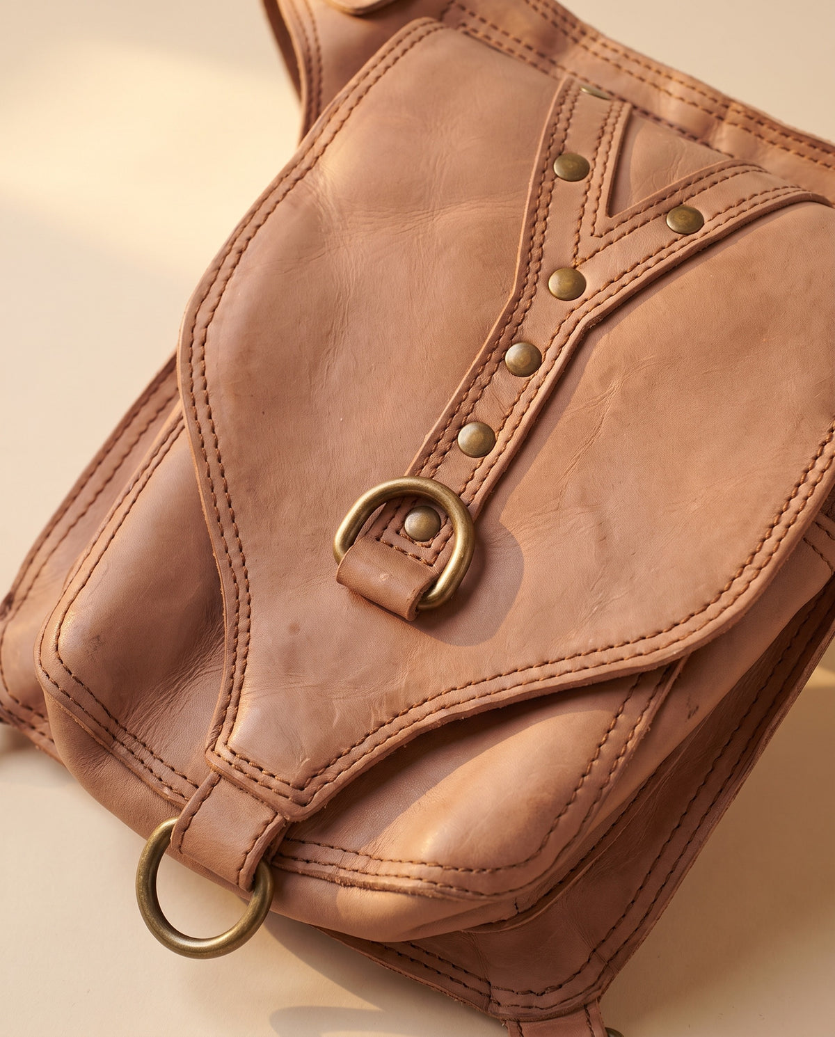 Blush studded leather hip belt bag, detail close-up, by Ya Qalbi