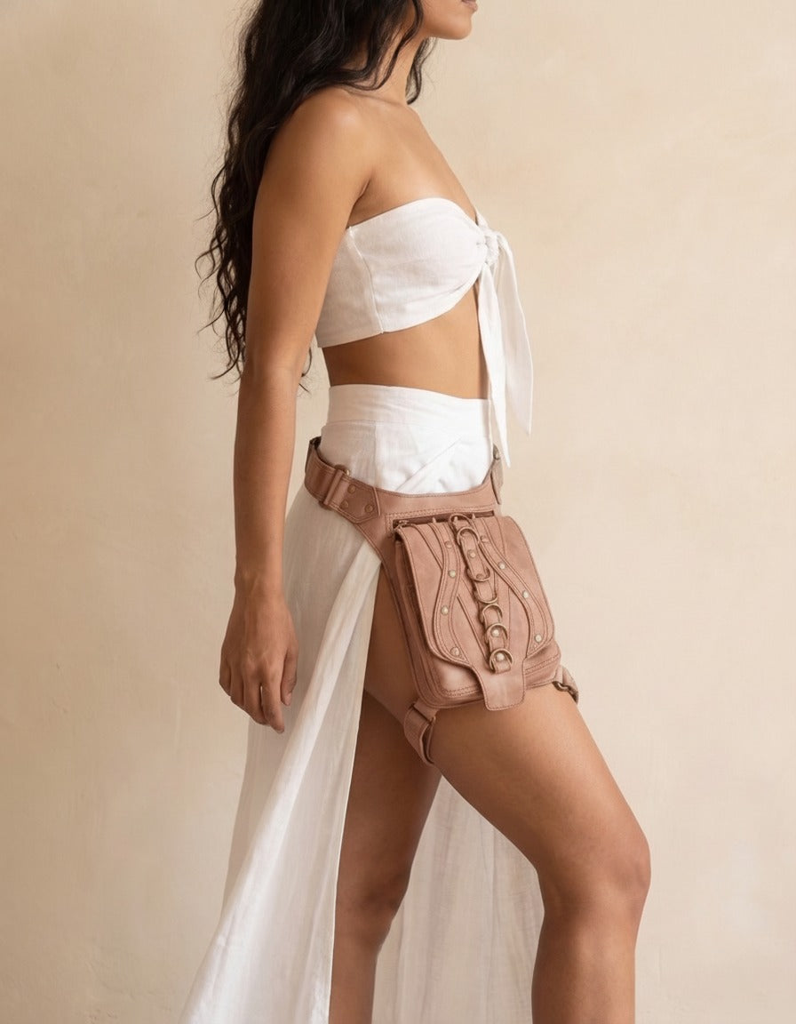 Blush studded leather hip belt bag, worn by a model, by Ya Qalbi