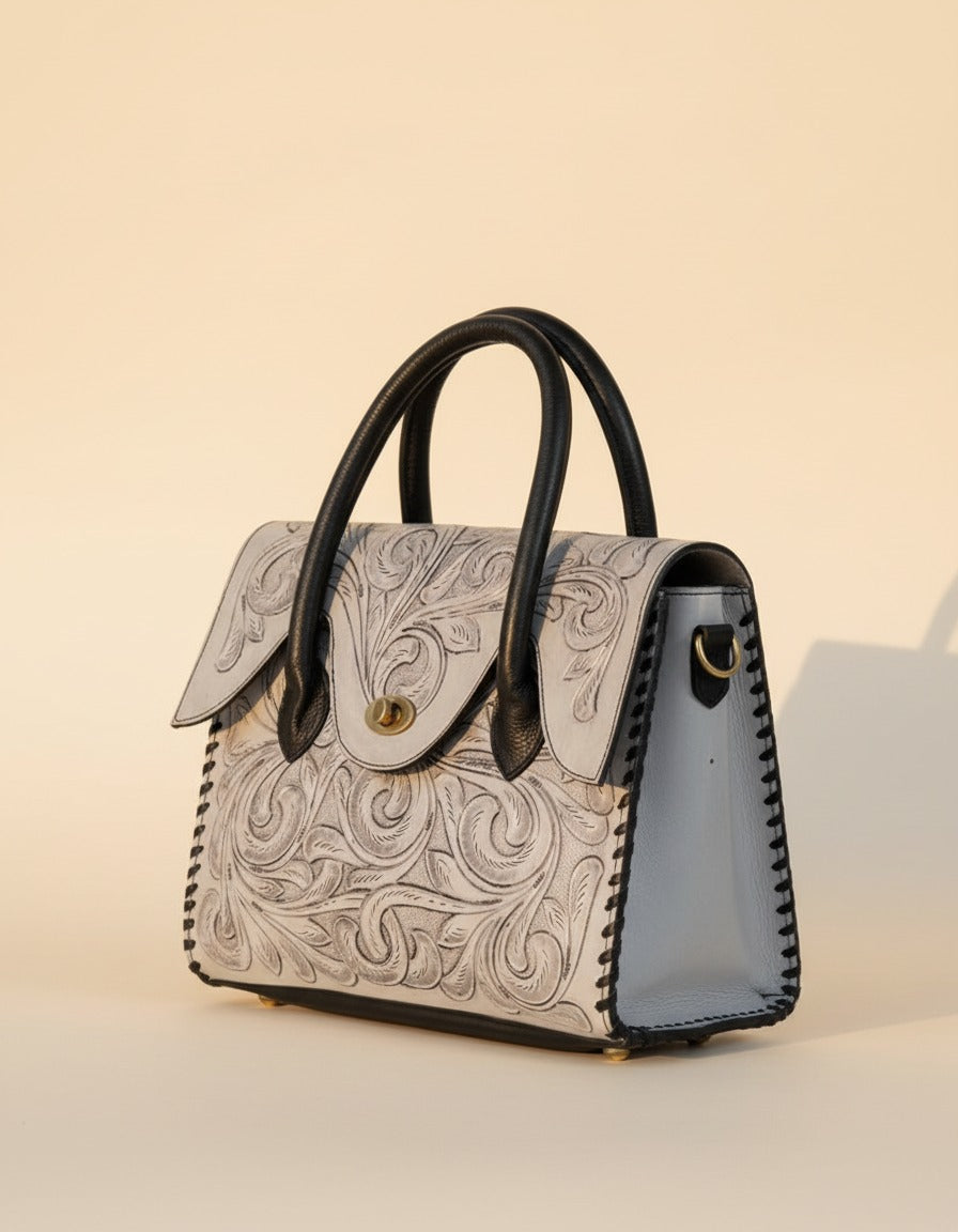 Grey hand-tooled leather top-handle handbag, angled view, by Ya Qalbi