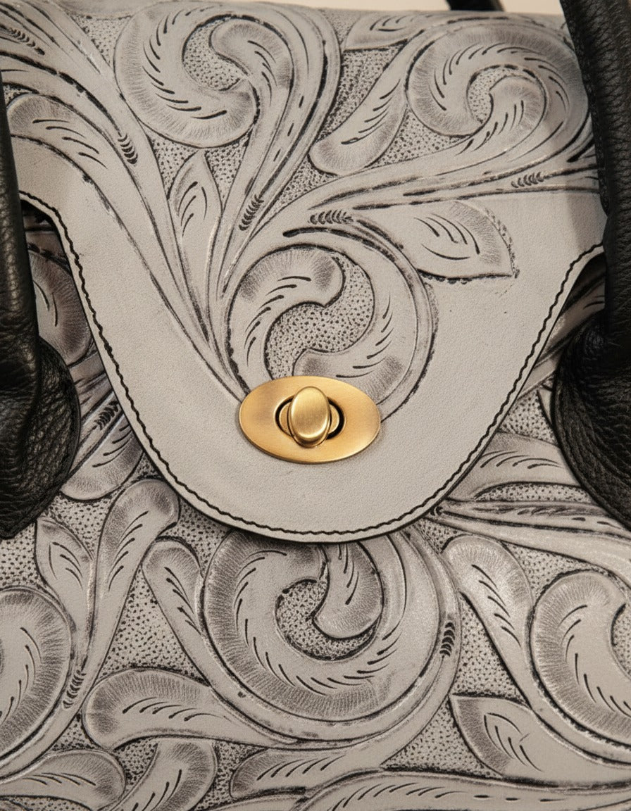 Grey hand-tooled leather top-handle handbag, detail close-up, by Ya Qalbi