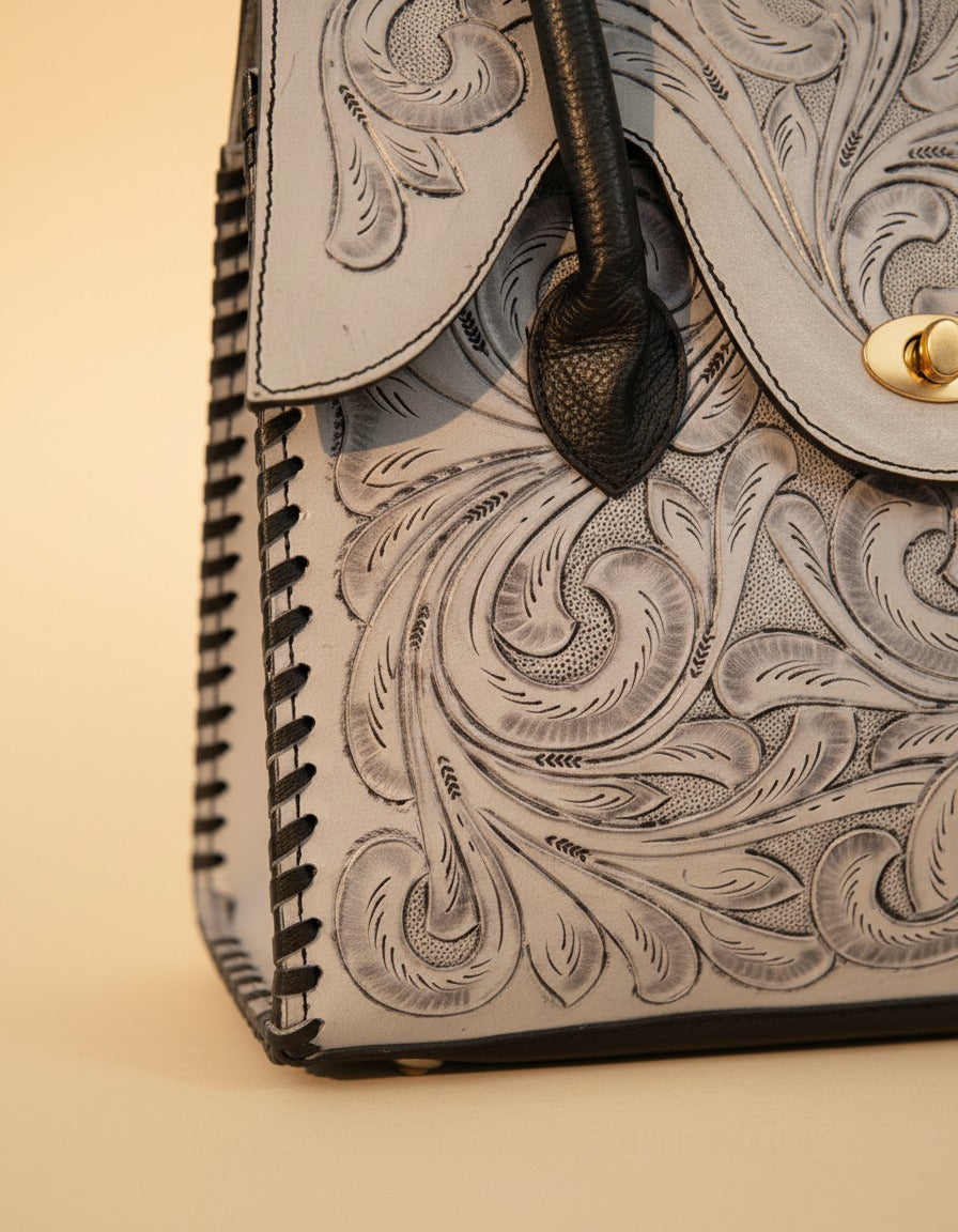 Grey hand-tooled leather top-handle handbag, detail close-up, by Ya Qalbi