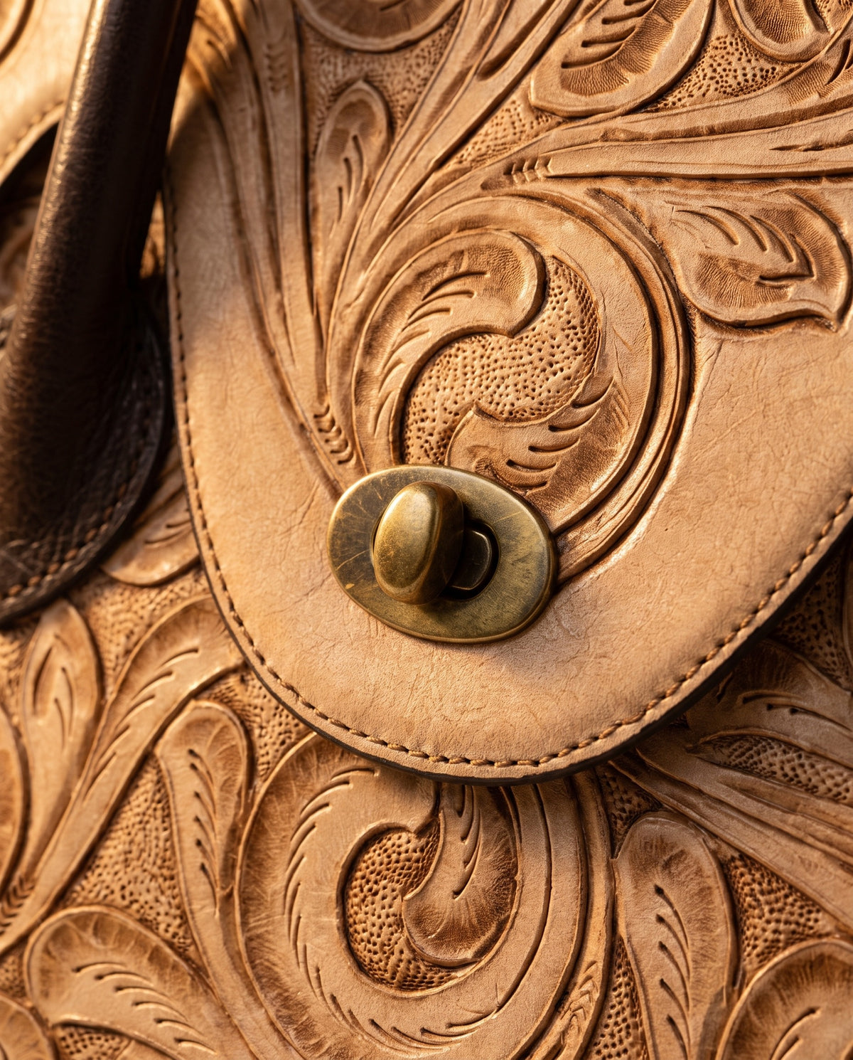 Tan hand-tooled leather top-handle handbag, detail close-up, by Ya Qalbi