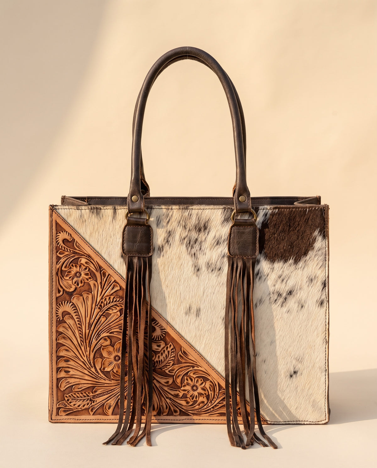 Tan tooled triangle hair-on cowhide leather tote with fringe, front view, by Ya Qalbi