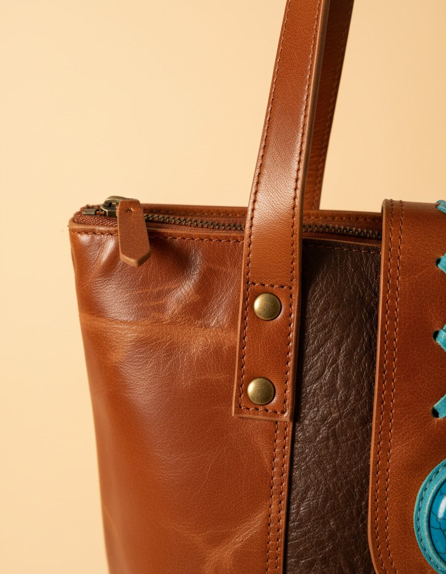 Brown tooled panel crunch leather tote with turquoise stone, zip and rivets close-up, by Ya Qalbi