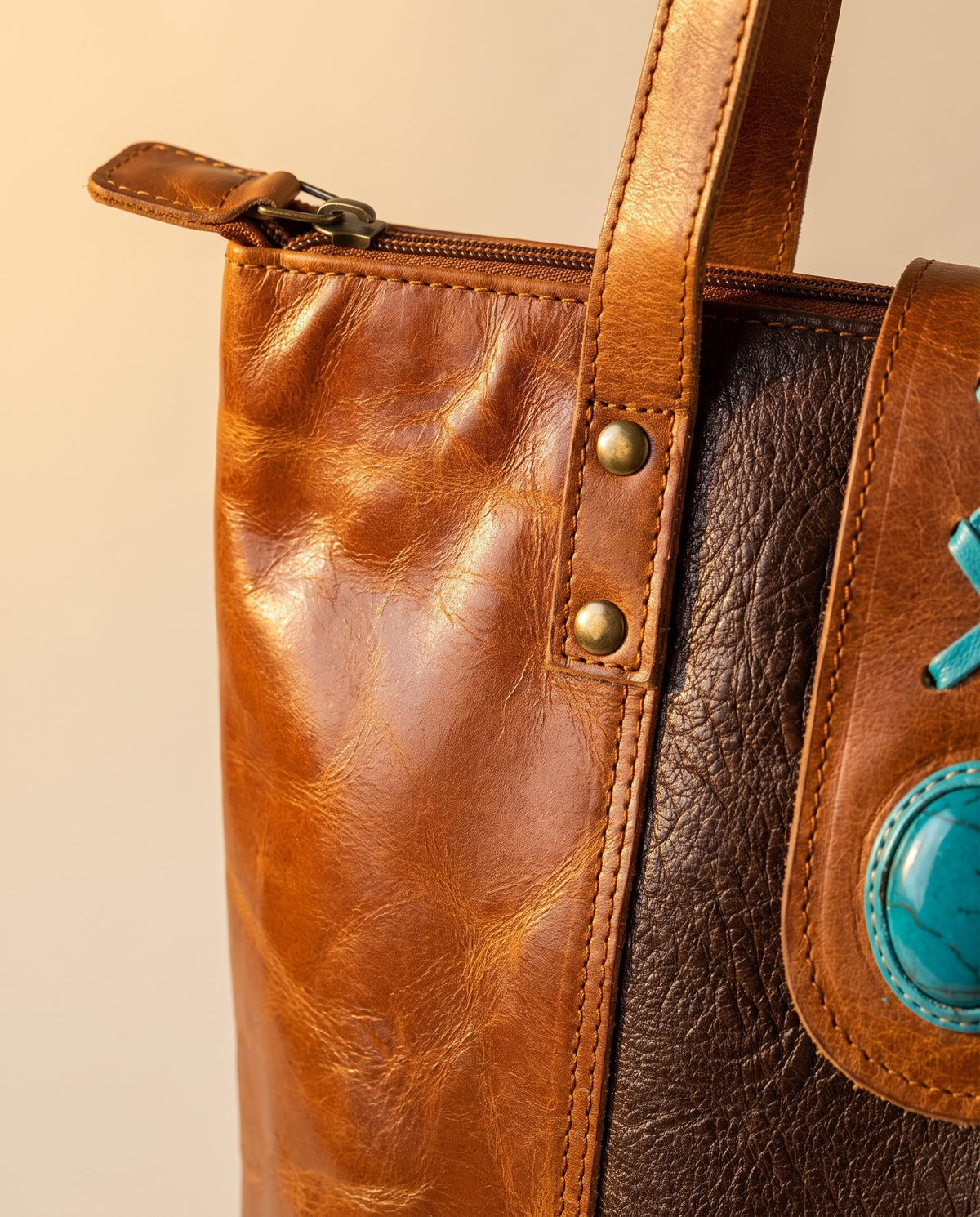 Dark brown panel crunch leather tote with turquoise stone, zip and rivets close-up, by Ya Qalbi