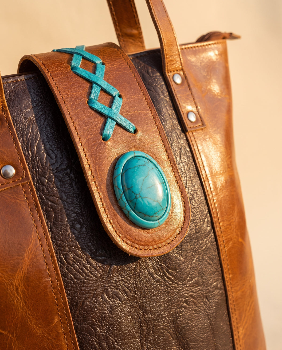 Dark brown panel crunch leather tote with turquoise stone, turquoise stone tab and lacing close-up, by Ya Qalbi