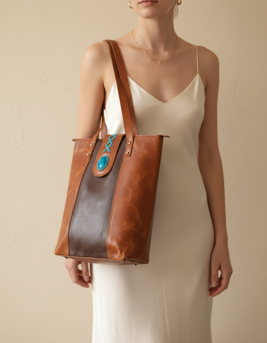 Dark brown panel crunch leather tote with turquoise stone, worn on the shoulder, by Ya Qalbi